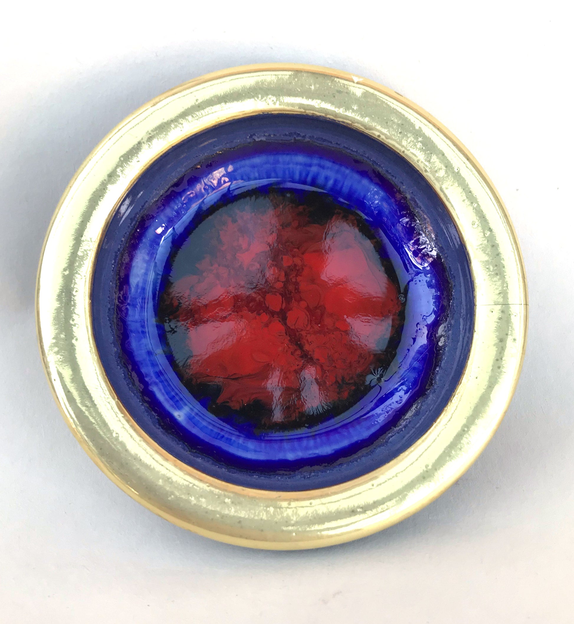 Gold rimmed bowl with red glass and blue glaze 8 cms