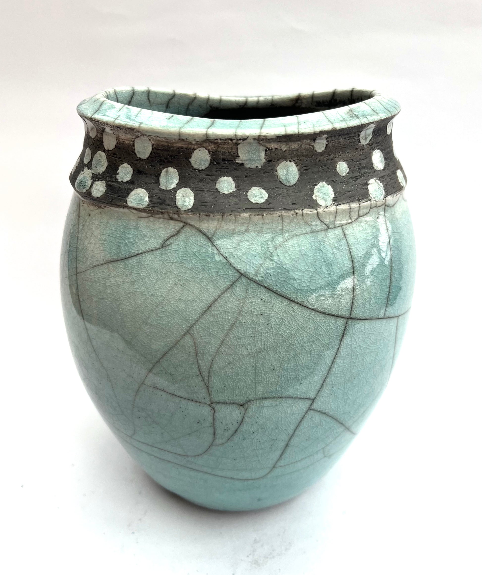 Spotted and poured raku form